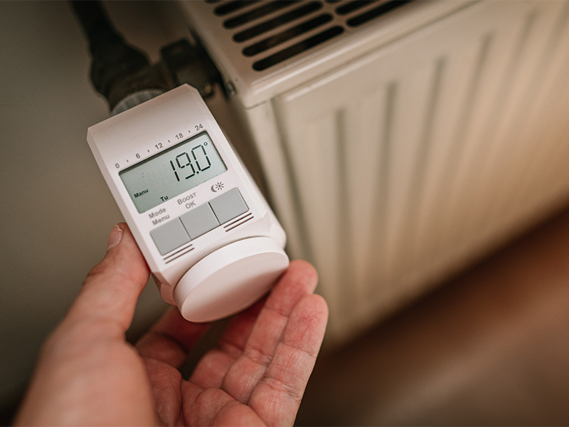 Elektronisches Thermostat an Heizung auf 19 °C eingestellt – Symbol für „Kosten Heizungsmodernisierung.